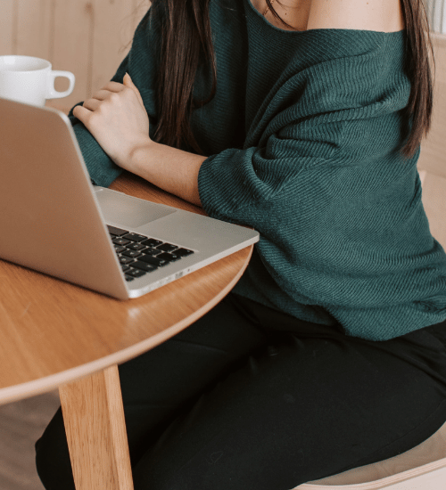 Woman working on laptop from kitchen