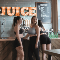 Women at a juice bar wearing sports bras